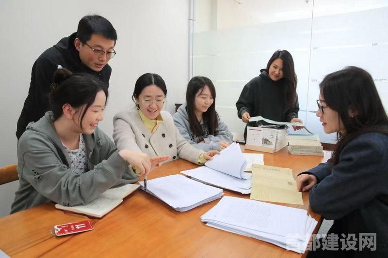 北京出版集团主题分公司职工正在讨论版式设计